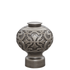 Decorative metal finial with intricate patterns on a white background